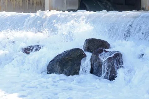 Small artificial water fall from water treatment pland. Water coming out from Stock Photos