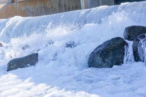 Small artificial water fall from water treatment pland. Water coming out from Stock Photos