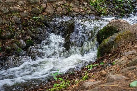 Small artificial waterfall in the park. Stock Photos