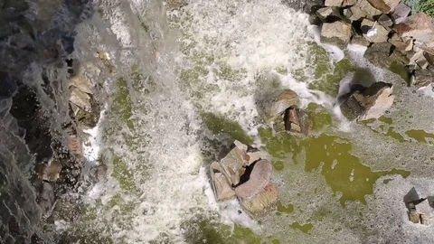 Small artificial waterfall view from the top. Waterfall is flowing down from Stock Footage 78672662