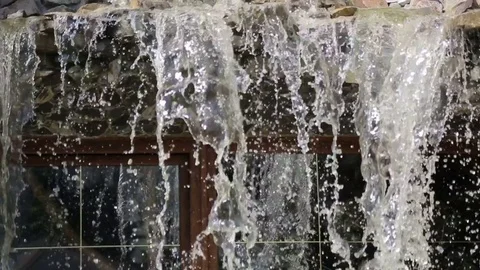 Small artificial waterfall view from the top. Stock Footage 78672857