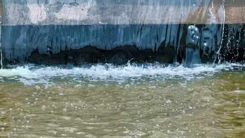 A small artificial waterfall in which water falls evenly down. Stock Footage 241099932