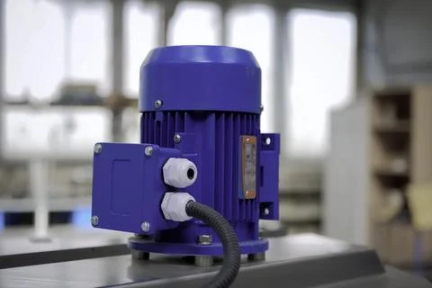 A small asynchronous electric motor mounted on equipment. Stock Photos