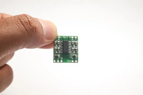 A small audio amplifier module held in one hand is used as DIY material for t Stock Photos