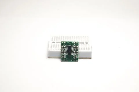A small audio amplifier module rests on a project board used as DIY material  Stock Photos