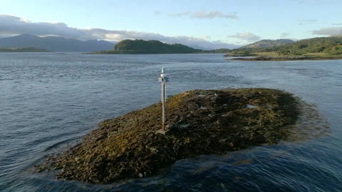 Small auto light beacon near Isle of Eriska, Scotland; aerial orbit and overhead Stock Footage 204924301