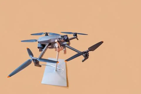 Small automatic electronic drone with camera and four propellers. Modern drone Stock Photos