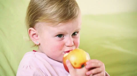 Small baby eating apple. Stock Footage 37014252