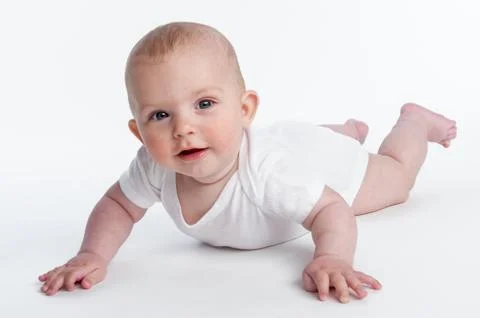 Small baby learning to crawl Stock Photos