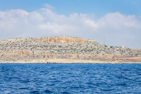 Small backwater surrounded by a stone cliff with azure water in Cyprus Stock Photos