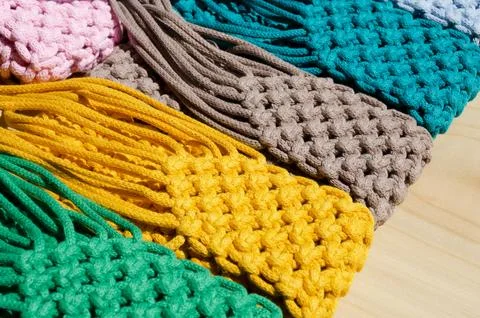 Small bags knitted using the macrame technique from cotton cord. Stock Photos