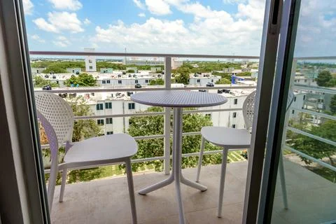 Small balcony with table and chairs city view Stock Photos
