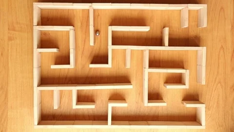 A small ball navigating wooden maze from top view Stock Footage 322131887