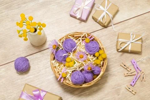 Small balls of thread in a basket. Gift boxes. Clothespins 스톡 사진
