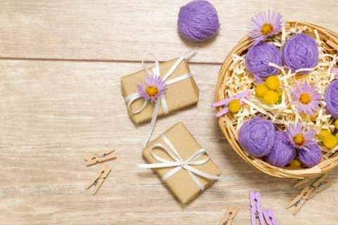 Small balls of thread in a basket. Gift boxes. Clothespins Stock Photos