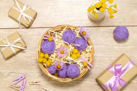 Small balls of thread in a basket. Gift boxes. Clothespins 스톡 사진