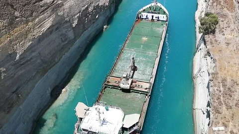Small barge pulls a big ship in the Corinth Canal. Stock Footage 119269999