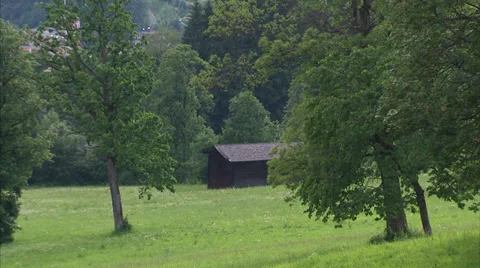 Small barn and pan to church in Kitzbühel Stock Footage 34862108