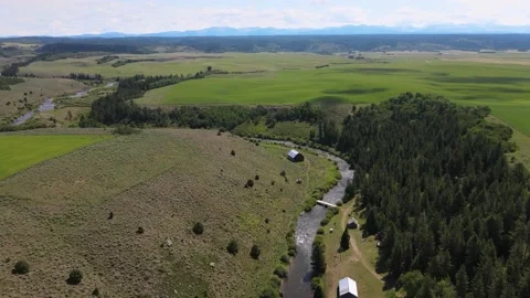 Small Barn Next to Creek River Summer Mountains in Background Snake River Stock Footage 154142406