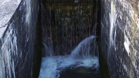 Small basic concrete lake dam to river. old dam in countryside. Stock Footage 118521848