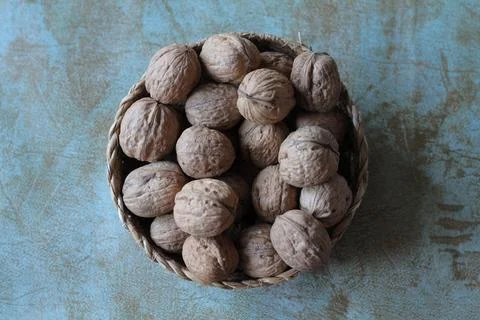 A small basket full of walnuts Stock Photos