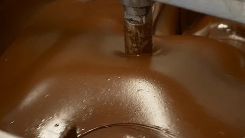 Small-batch, hand-crafted chocolate blending in large bowl. Video stock 100644931