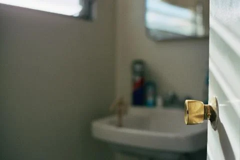 A small bathroom with a gleam of sunlight Stock Photos