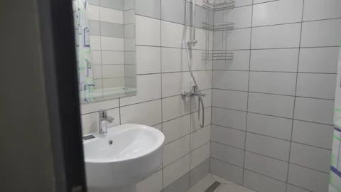 Small bathroom includes corner shower toilet and sink Video stock 311389190