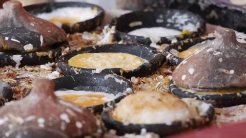Small batter cakes bake and brown in round molds on a hot griddle at a market fo Stock Footage 340881095