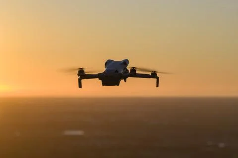 Small battery powered drone in flight above rural landscape, performing aer.. Stock-Fotos