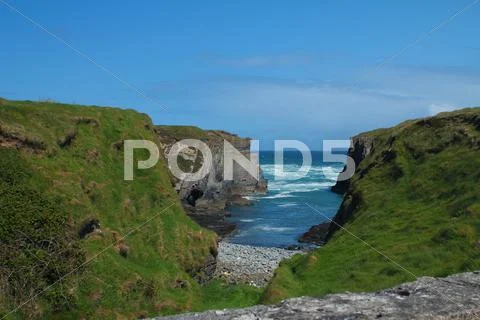 Small bay and grassy cliffs. Stock Photos