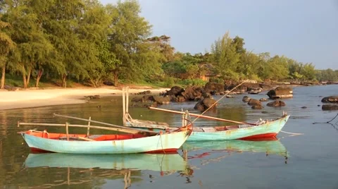 Small bay between rocks with two blue green small fishing boat ship Stock Footage 56151813