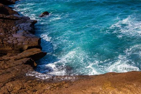 Small bay with foamy waves surrounded by stones in Tenerife Stock Photos