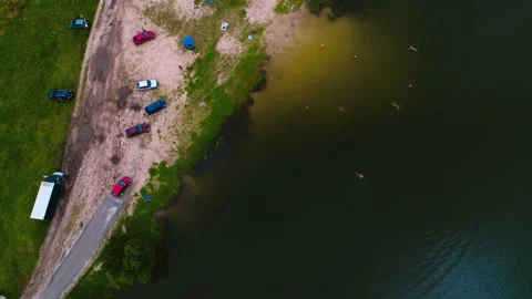 A small beach on the banks of the river where children and adults bathe Stock Footage 119521859