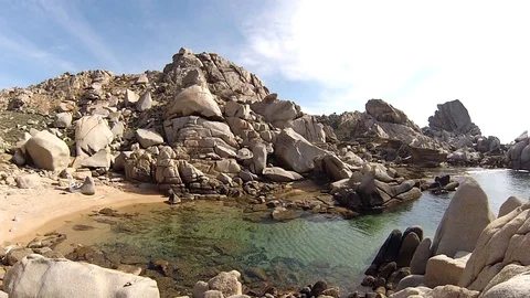 Small beach in a hidden bay  Stock Footage 128707023