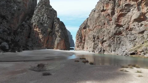 Small beach surrounded by mountains and cliffs Stock Footage 126911500