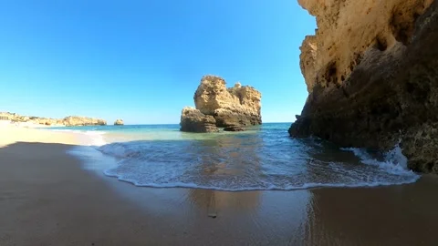 Small beach wave foam washing over the beach in Albufeira Algarve Portugal Stock Footage 196259533