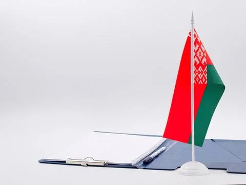 Small belarus flag with notebook and pen on white background Stock Photos