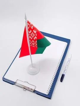 Small belarus flag on notebook with pen on white background Stock Photos