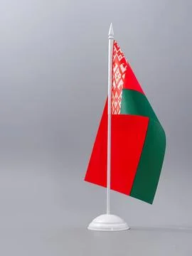 Small belarus flag on a white stand against gray background Stock Photos
