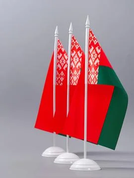 Small belarus flags on white stands with gray background Stock Photos