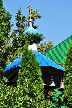 Small bell tower. Bell tower under a blue roof with bells. Stock Photos