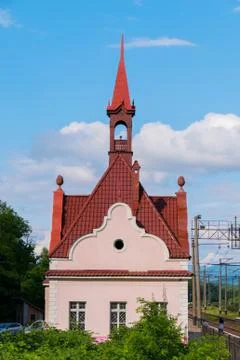 A small bell tower with a red tiled roof near the railway tracks Stock Photos