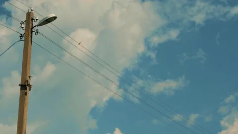 A small bird is sitting on an electric wire near a lamppost Video stock 201214421