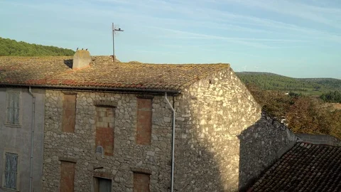Small birds flying and jumping over the rooftop of the old medieval house in the Stock Footage 121614554