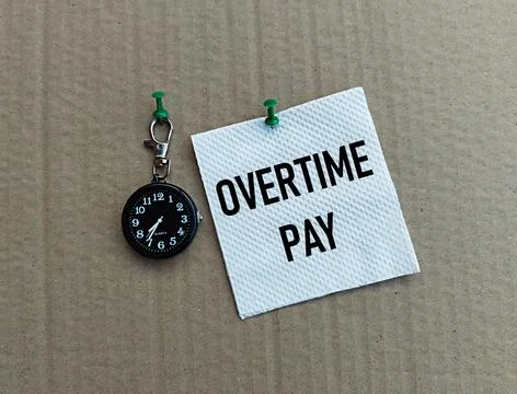 Small black clock and white tissue printed overtime pay on a gray background Foto stock