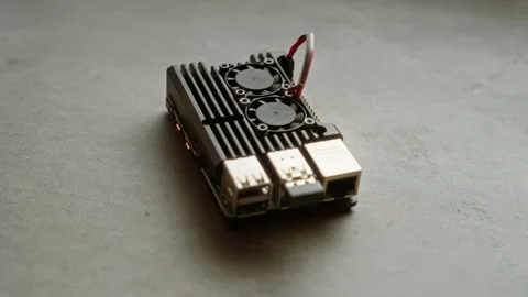 Small black computer with dual fans placed on concrete surface viewed from .. Stock Footage 295255841