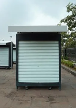 A small black container booth equipped with wheels at the bottom, usually u.. Stock Photos