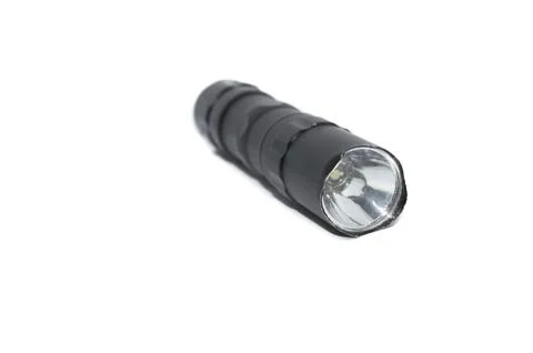 Small black flashlight tactical for camping and hiking trails isolated on whi Stock Photos