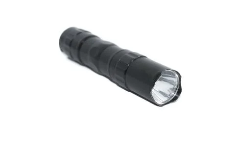 Small black flashlight tactical for camping and hiking trails isolated on whi Stock Photos